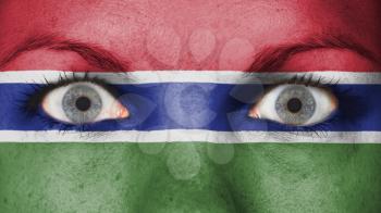 Close up of eyes. Painted face with flag of The Gambia
