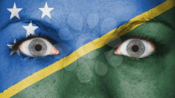 Close up of eyes. Painted face with flag of The Solomon Islands