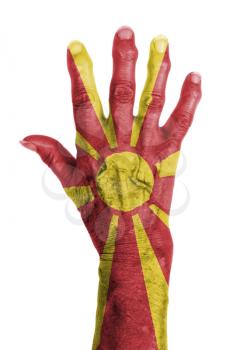 Hand of an old woman wrapped in flag of Macedonia