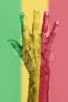 Hand of an old woman wrapped in flag of Mali