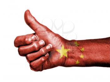 Old woman with arthritis giving the thumbs up sign, wrapped in flag pattern, China