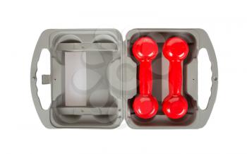 Red dumbbells in a grey case, isolated on white