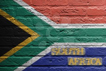 Brick wall with a painting of a flag isolated, South Africa