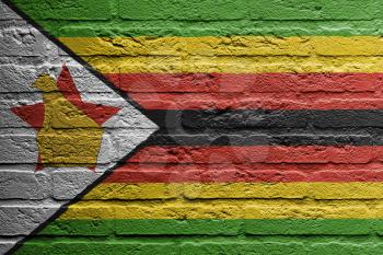 Brick wall with a painting of a flag isolated,  Zimbabwe