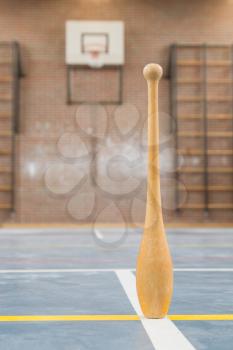 Wooden pin on a blue basketball court
