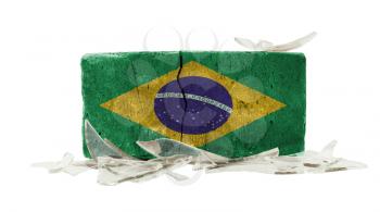 Brick with broken glass, violence concept, flag of Brazil