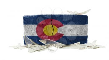 Brick with broken glass, violence concept, flag of Colorado