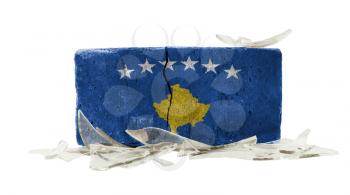 Brick with broken glass, violence concept, flag of Kosovo