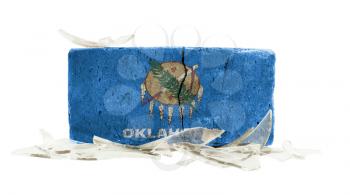 Brick with broken glass, violence concept, flag of Oklahoma
