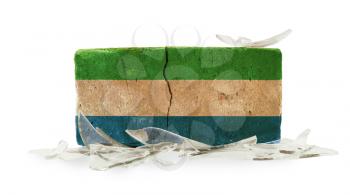 Brick with broken glass, violence concept, flag of Sierra Leone