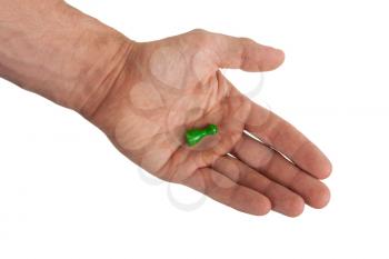 Hand holding a green pawn, isolated on white