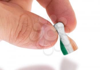 Hand holding wooden pawn with a flag painting, selective focus, Ireland