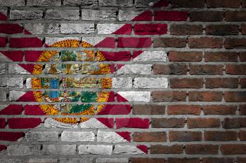 Very old dark red brick wall texture with flag - Florida