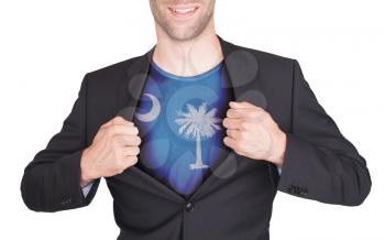 Businessman opening suit to reveal shirt with state flag (USA), South Carolina