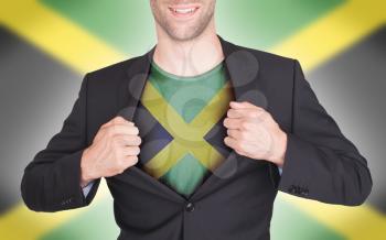Businessman opening suit to reveal shirt with flag, Jamaica