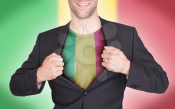 Businessman opening suit to reveal shirt with flag, Mali