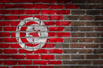 Very old dark red brick wall texture with flag - Tunisia