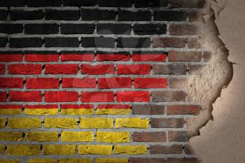Dark brick wall texture with plaster - flag painted on wall - Germany