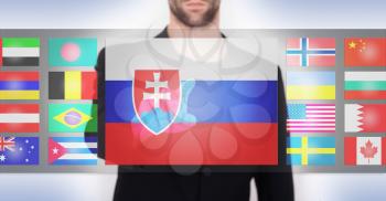 Hand pushing on a touch screen interface, choosing language or country, Slovakia