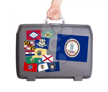 Used plastic suitcase with stains and scratches, stickers of US States, Virginia