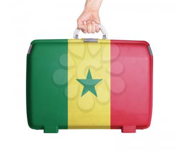 Used plastic suitcase with stains and scratches, printed with flag, Senegal