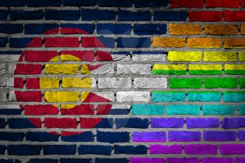 Dark brick wall texture - coutry flag and rainbow flag painted on wall - Colorado