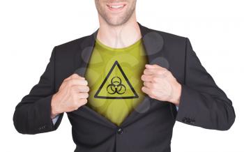 Businessman opening suit to reveal shirt with symbol, biohazard