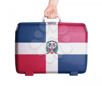 Used plastic suitcase with stains and scratches, printed with flag, Dominican Republic