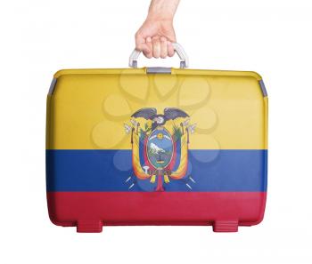Used plastic suitcase with stains and scratches, printed with flag, Ecuador