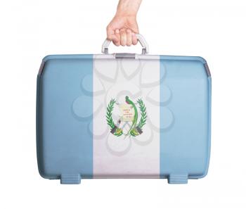 Used plastic suitcase with stains and scratches, printed with flag, Guatemala