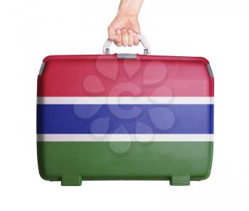 Used plastic suitcase with stains and scratches, printed with flag, Gambia