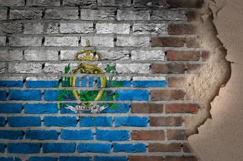 Dark brick wall texture with plaster - flag painted on wall - San Marino