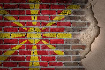 Dark brick wall texture with plaster - flag painted on wall - Macedonia