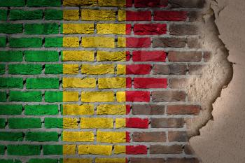 Dark brick wall texture with plaster - flag painted on wall - Mali