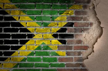 Dark brick wall texture with plaster - flag painted on wall - Jamaica