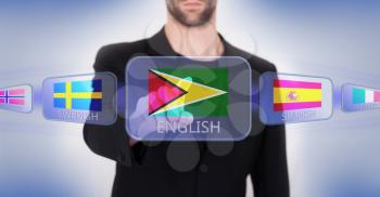 Hand pushing on a touch screen interface, choosing language or country, Guyana