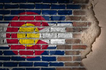 Dark brick wall texture with plaster - flag painted on wall - Colorado