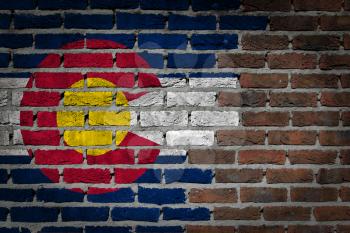 Very old dark red brick wall texture with flag - Colorado