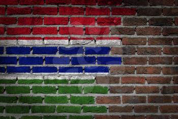 Very old dark red brick wall texture with flag - Gambia