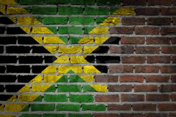 Very old dark red brick wall texture with flag - Jamaica