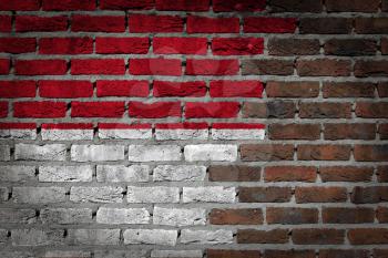 Very old dark red brick wall texture with flag - Monaco