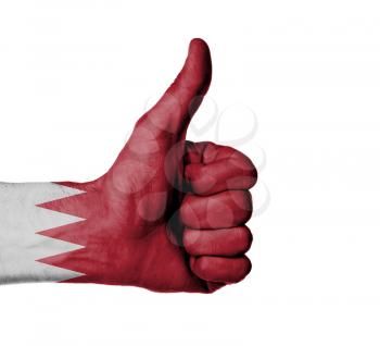 Closeup of male hand showing thumbs up sign against white background, Bahrain