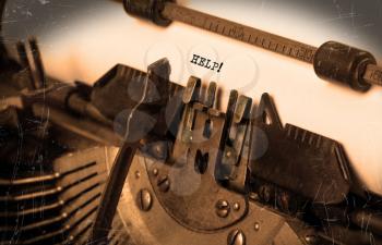 Close-up of an old typewriter with paper, selective focus, help