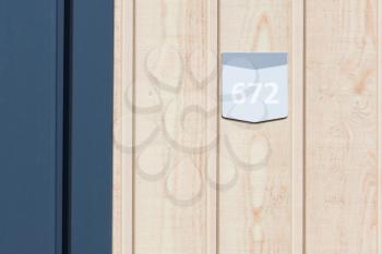 672 street number on a wooden bungalow