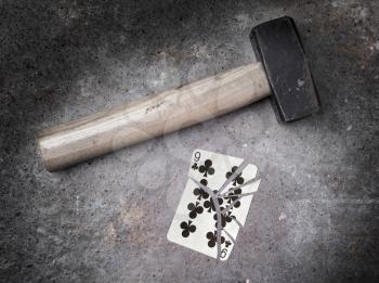 Hammer with a broken card, vintage look, nine of clubs