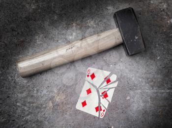 Hammer with a broken card, vintage look, six of diamonds