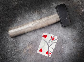 Hammer with a broken card, vintage look, four of hearts