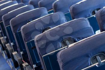 Empty old blue airplane seats in the cabin, selective focus