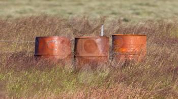 Old steel drums in a field in Iceland
