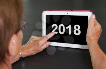 Senior lady relaxing and her tablet - New year - 2018